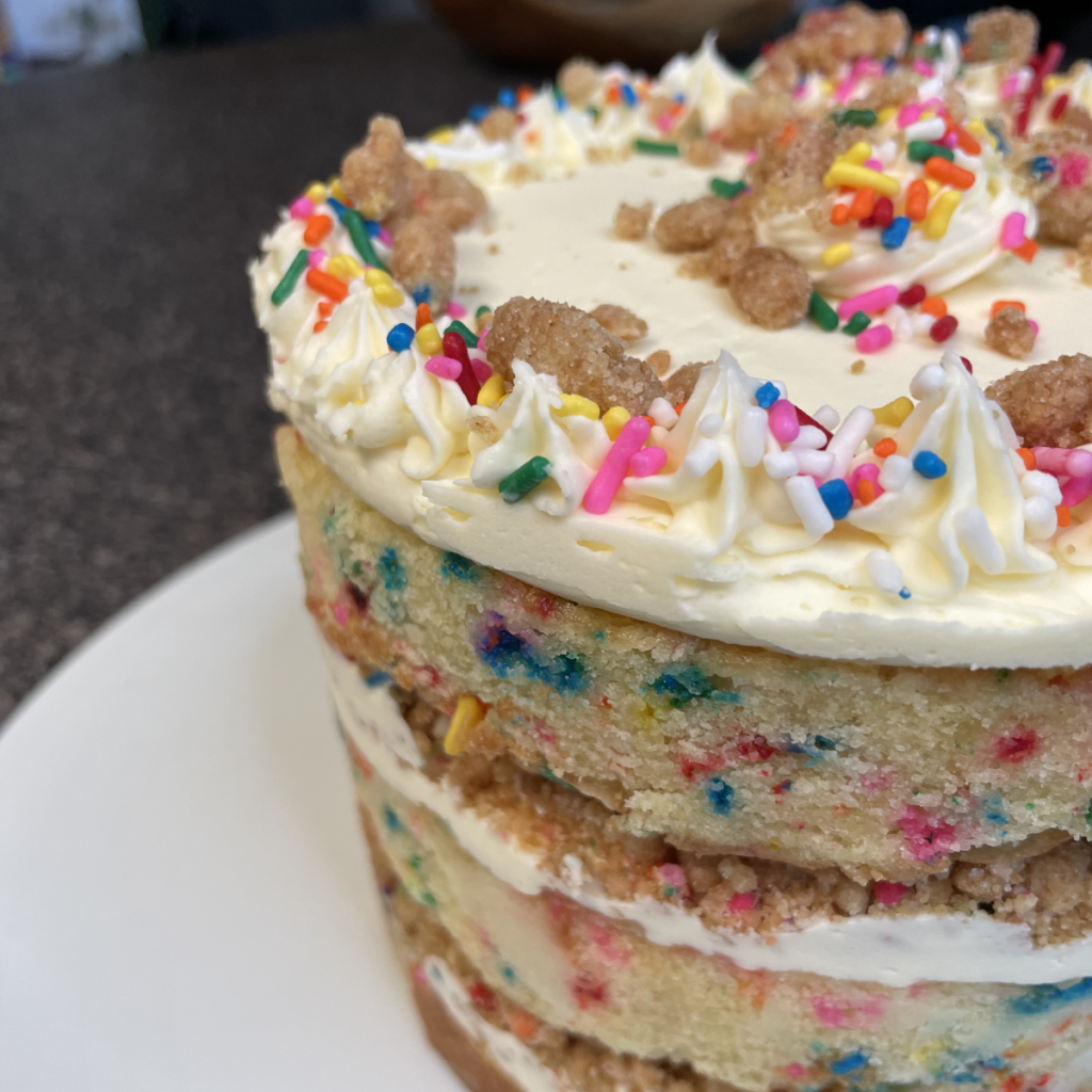 a close up of layered confetti cake