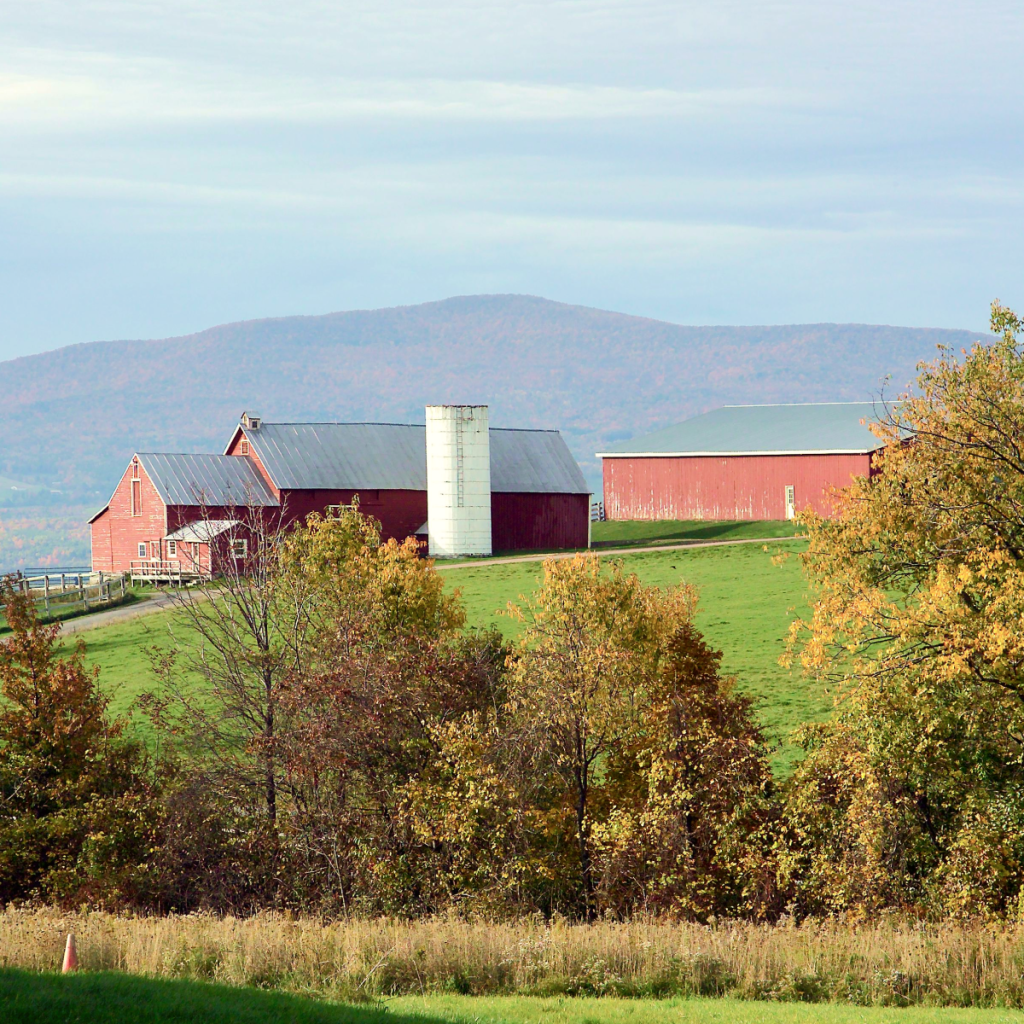 upstate new york landscape with mountains in background and farm and changing leaves in foreground